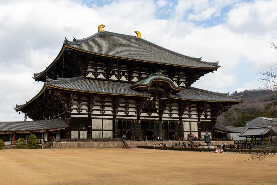 The Great Buddha Hall of Todai-ji, a very wide wooden temple building, seen head on across its forecourt.